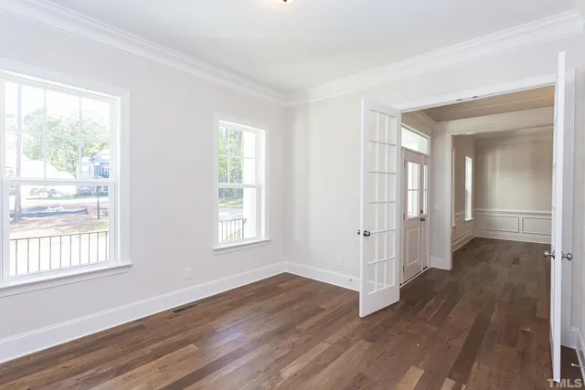 a view of a room with wooden floor closet and a window