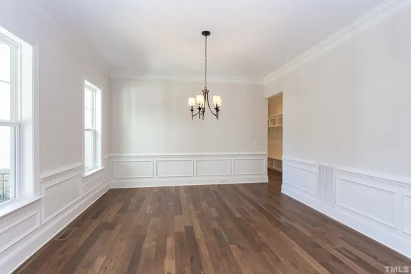 a view of a room with wooden floor and ceiling fan