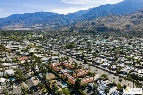 an aerial view of residential house and sandy dunes