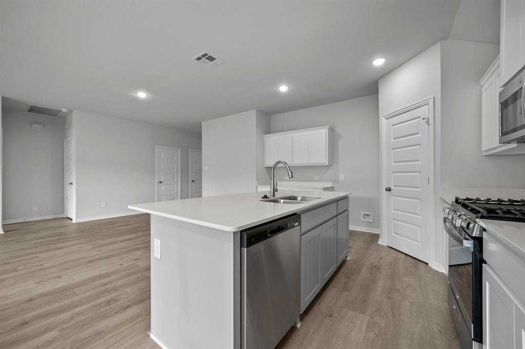 533 Hickory Rdg Drive Van Alstyne, TX 75495 - Photo 12 of 31 a kitchen with a sink stove and cabinets