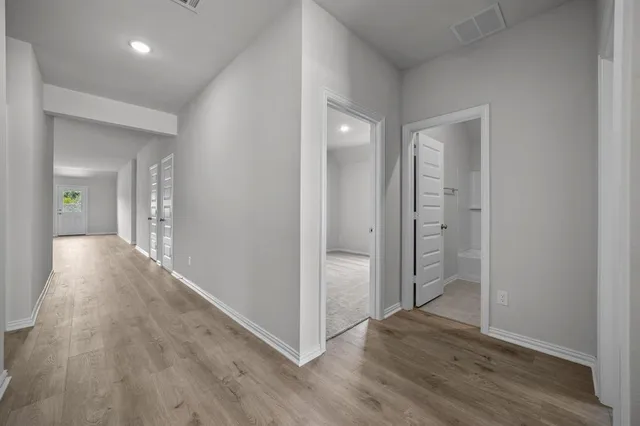 wooden floor with a chandelier