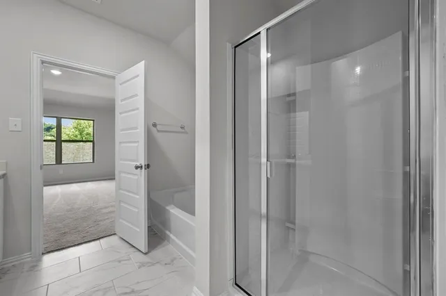 a bathroom with a shower and a sink