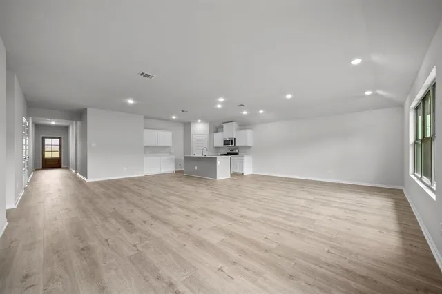 a view of kitchen with kitchen island sink and living room