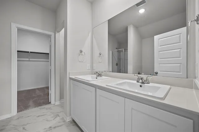 a bathroom with 2 sink and a mirror