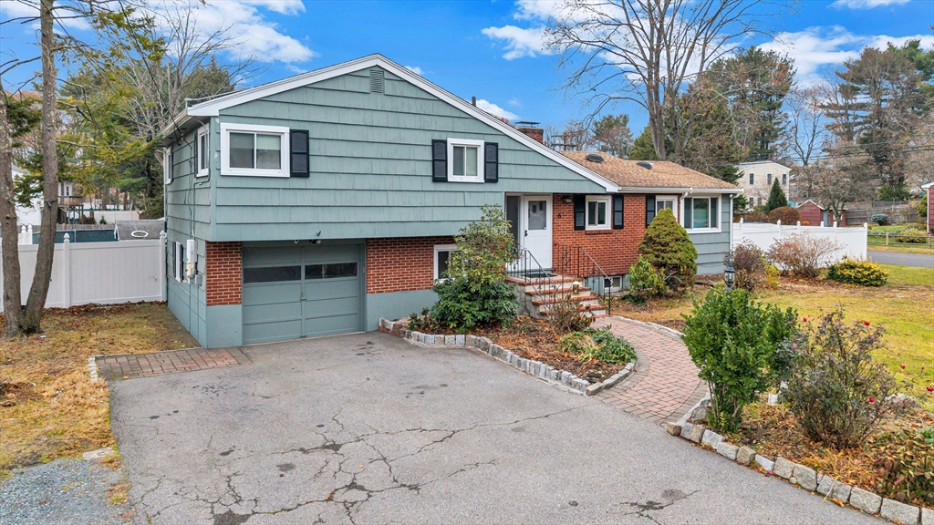 6 Woodward Road Framingham, MA 01701 - Photo 1 of 41 a front view of a house with a yard and garage