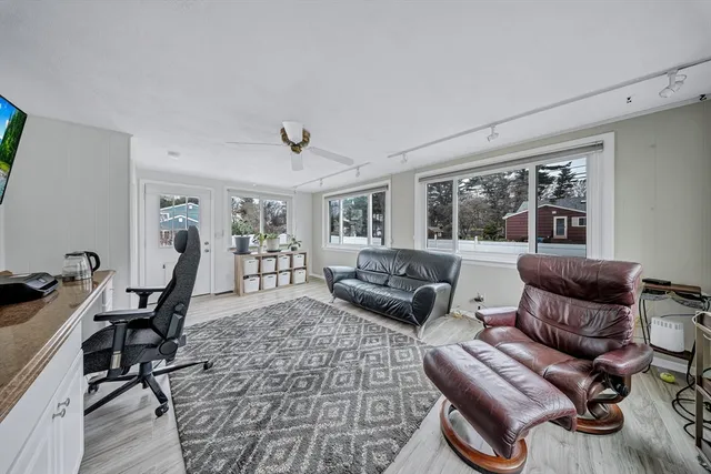 a living room with furniture rug and window