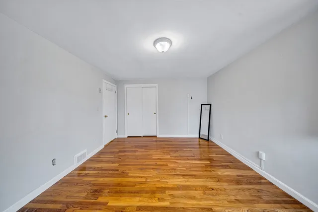 a view of a big room with wooden floor and natural light