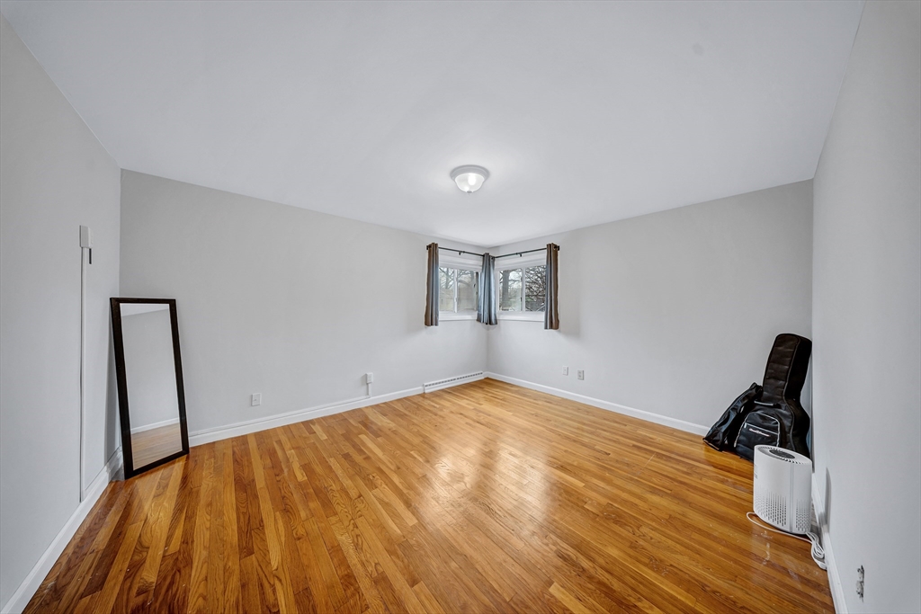 6 Woodward Road Framingham, MA 01701 - Photo 17 of 41 a view of a room with wooden floor and a ceiling fan