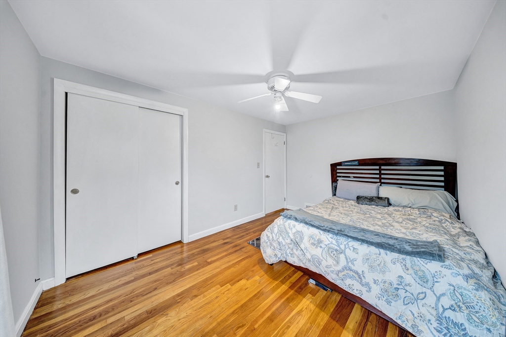 6 Woodward Road Framingham, MA 01701 - Photo 18 of 41 a bedroom with a bed and wooden floor