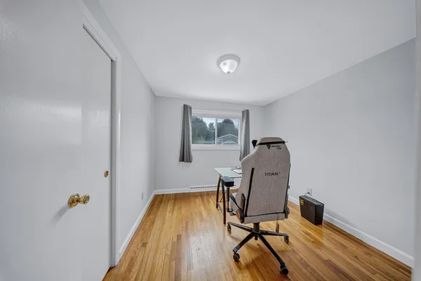 a work room with furniture and wooden floor