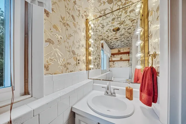 a bathroom with a sink and a mirror