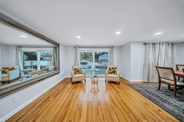 a living room with furniture and large windows