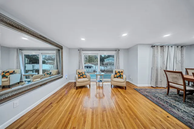 a living room with furniture and large windows