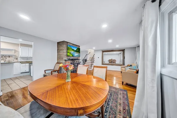 a living room with dining table a table and kitchen view