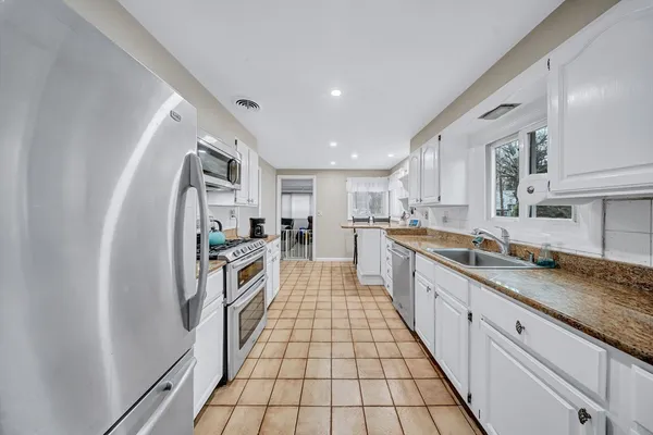 a large kitchen with stainless steel appliances lots of counter top space