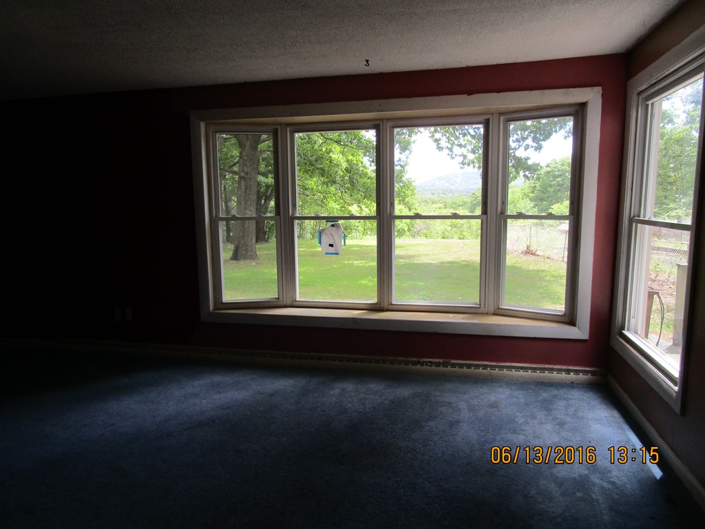 62 Worcester Road Westminster, MA 01473 - Photo 5 of 12 a view of empty room with wooden floor and fan
