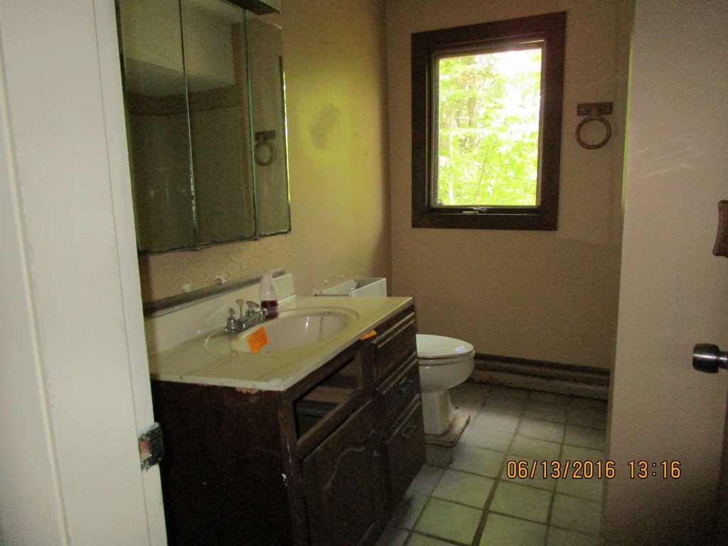 62 Worcester Road Westminster, MA 01473 - Photo 10 of 12 a bathroom with a granite countertop sink and a toilet