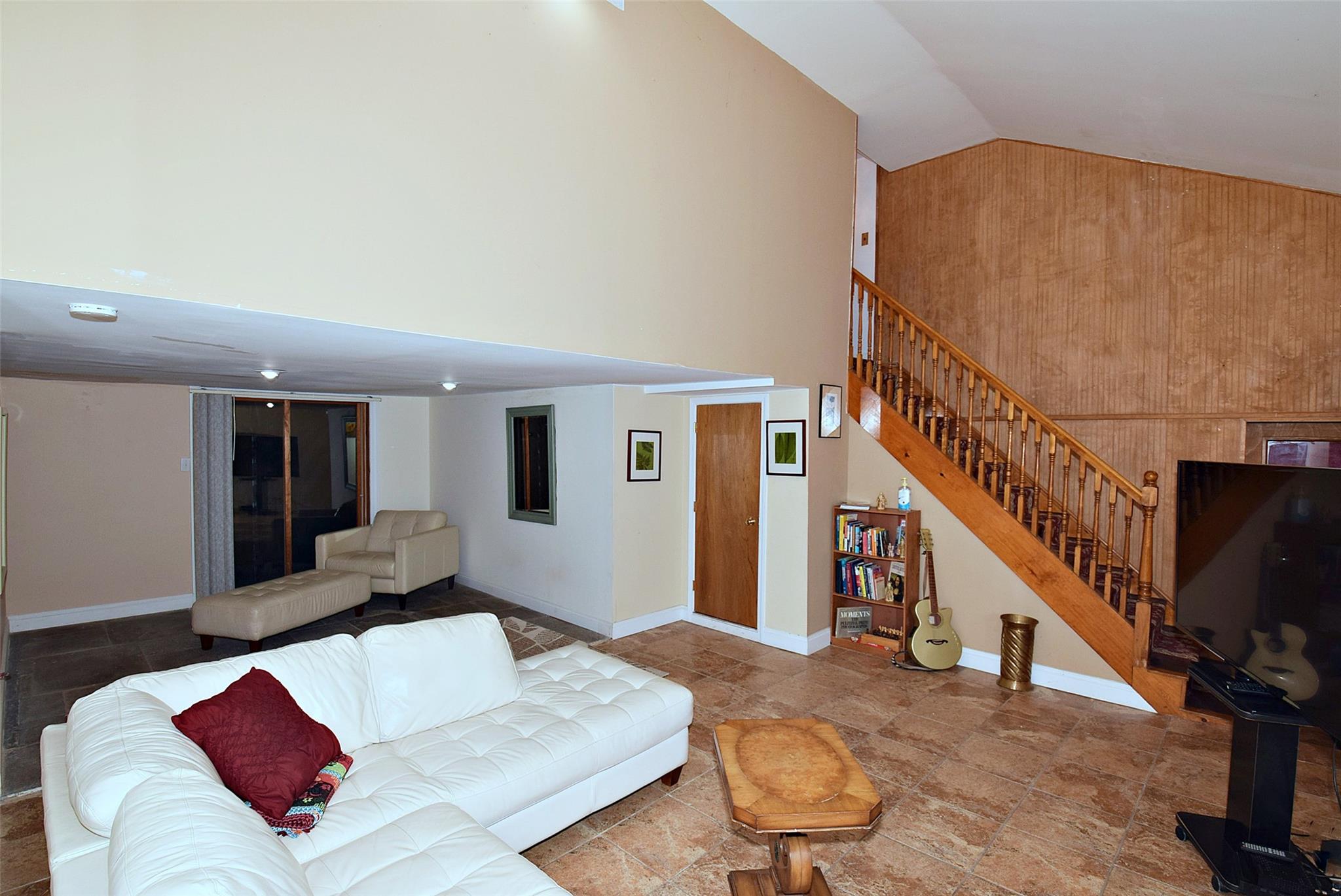 4941 Highway 52, Unit 1 Jeffersonville, NY 12748 - Photo 1 of 1 Living room with baseboards, stairway, and high vaulted ceiling