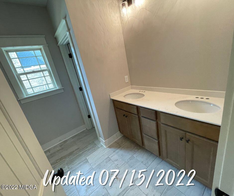 411 Stonegate Trail Perry, GA 31069 - Photo 13 of 14 a bathroom with a sink and a mirror