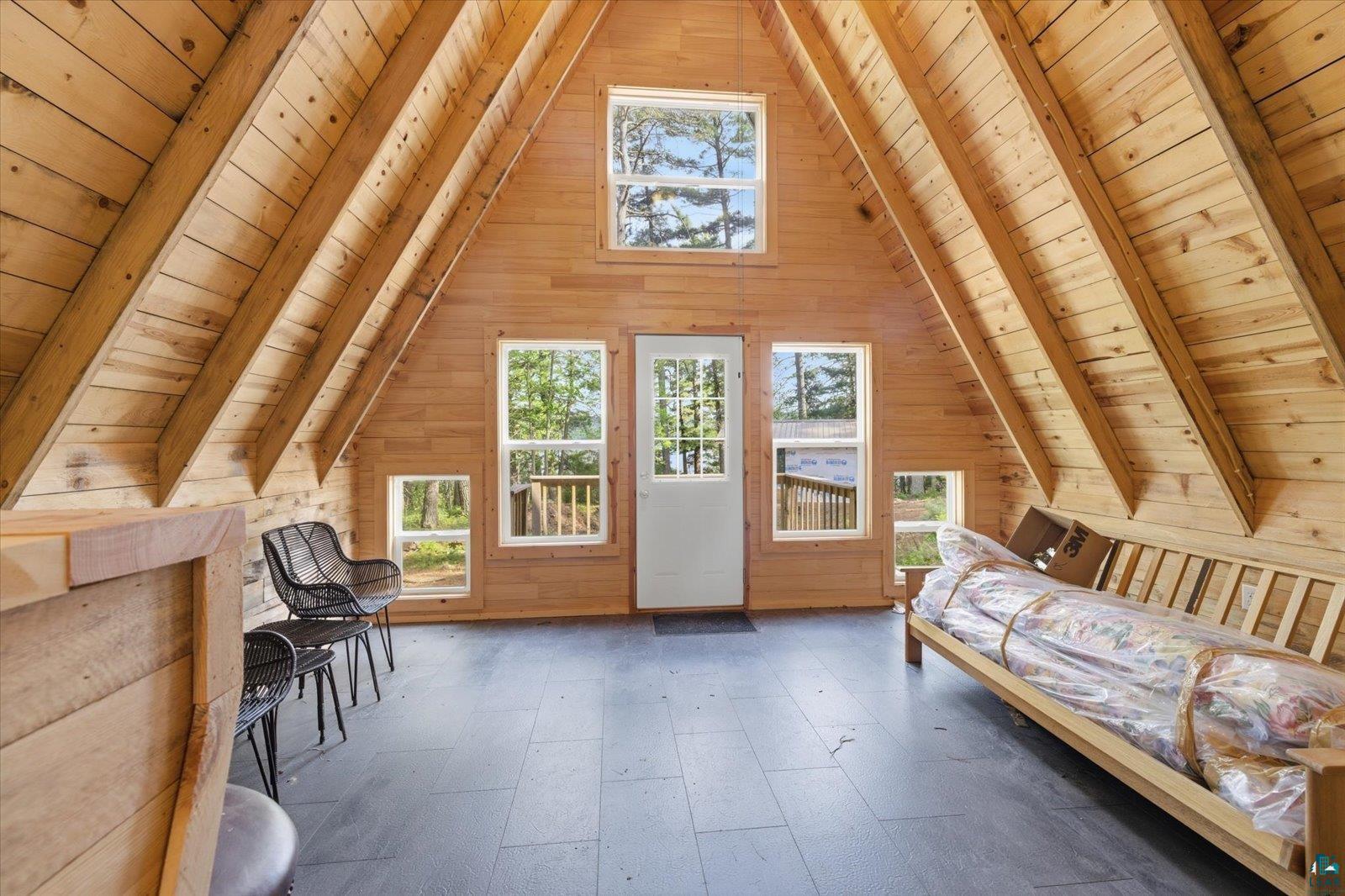 5298 Long Island Tower, MN 55790 - Photo 5 of 31 A-frame interior featuring natural wood paneling and exposed wood beams