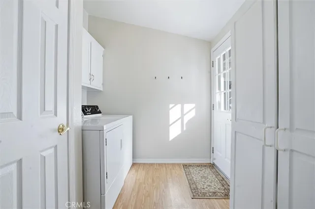 a room with white cabinets and window