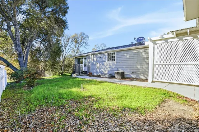 a view of a yard with plants and trees