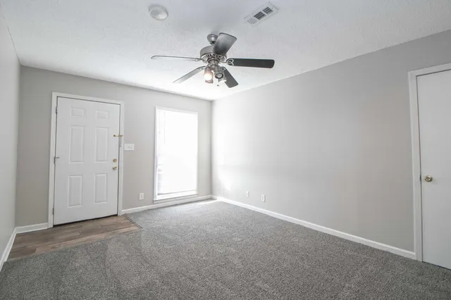 a view of an empty room with a window