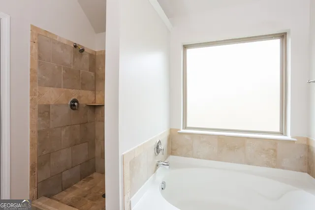 a bathroom with a bathtub and shower