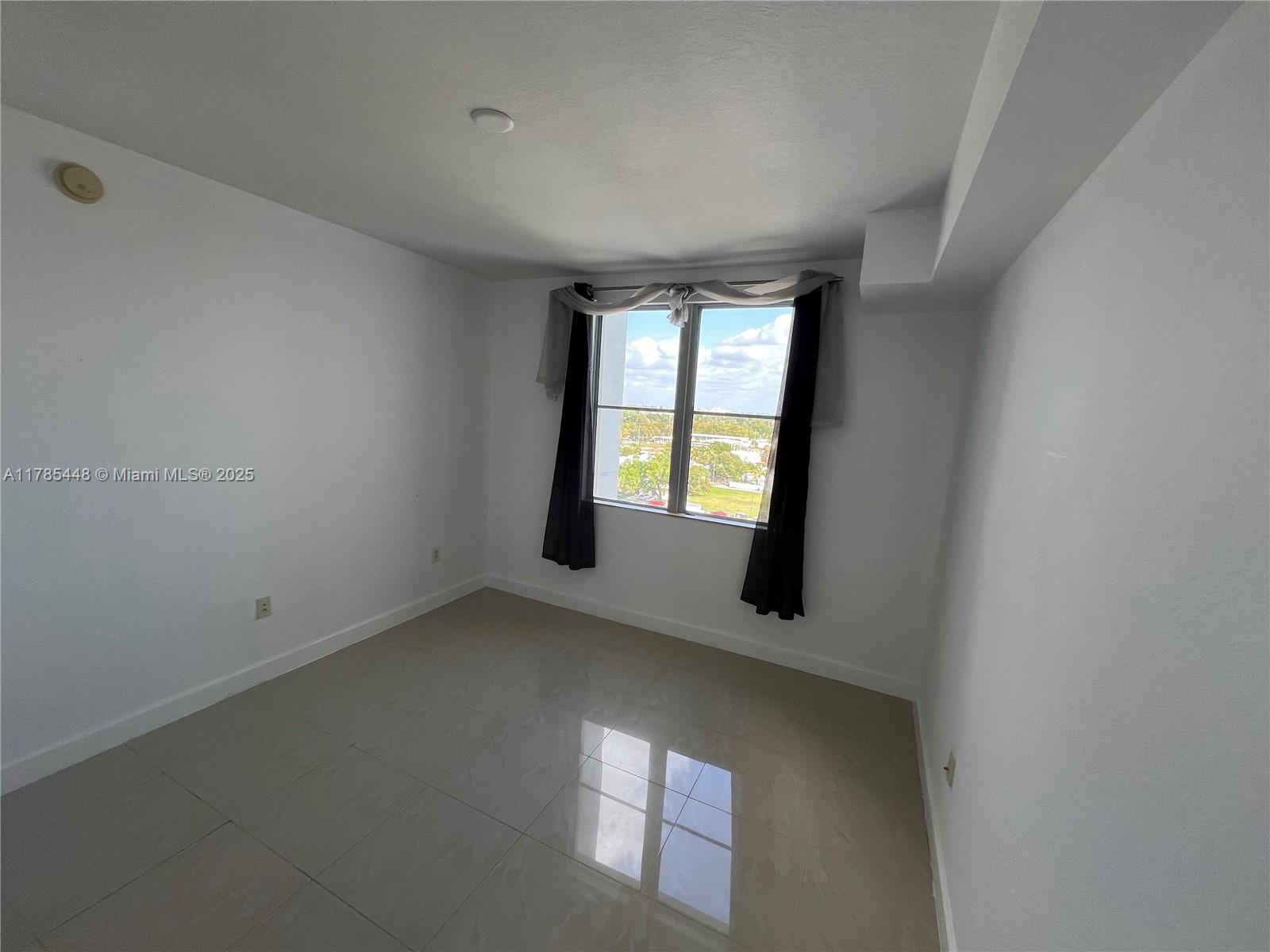 1830 Radius Drive, Unit 909 Hollywood, FL 33020 - Photo 12 of 22 an empty room with windows