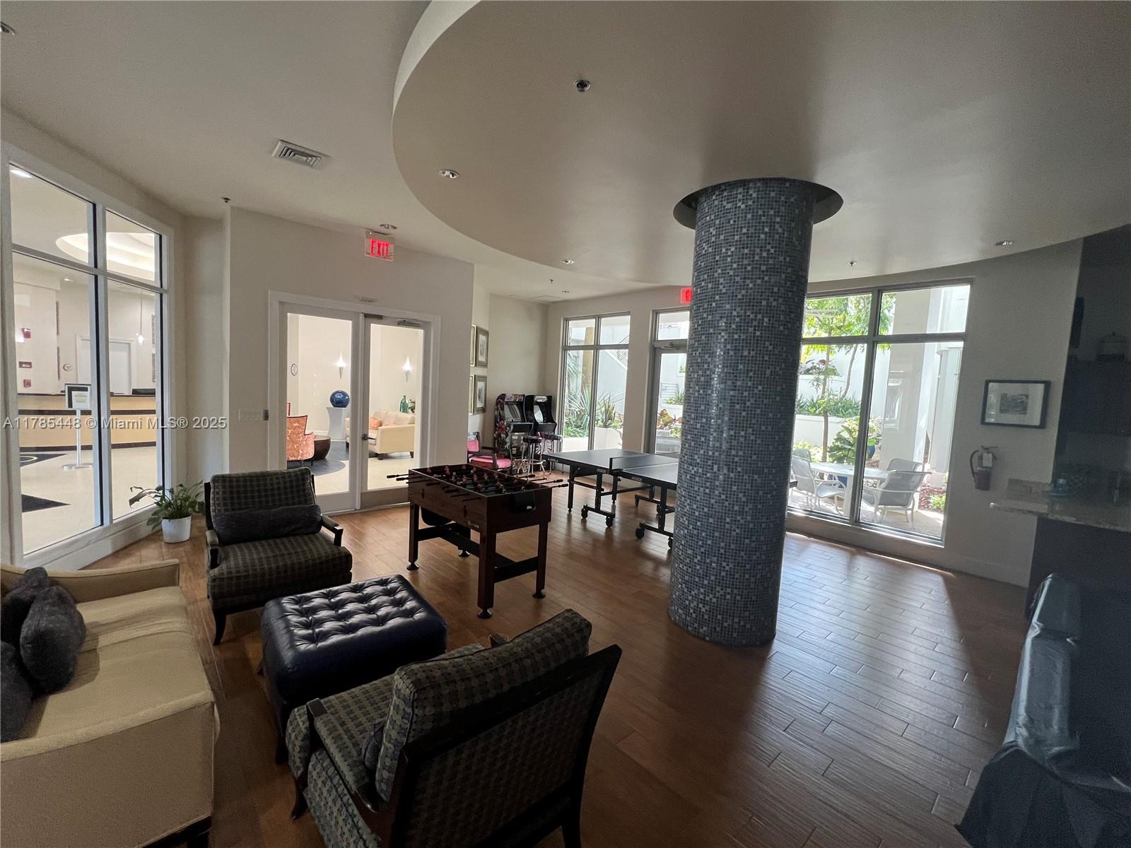 1830 Radius Drive, Unit 909 Hollywood, FL 33020 - Photo 18 of 22 a living room with furniture and a large window