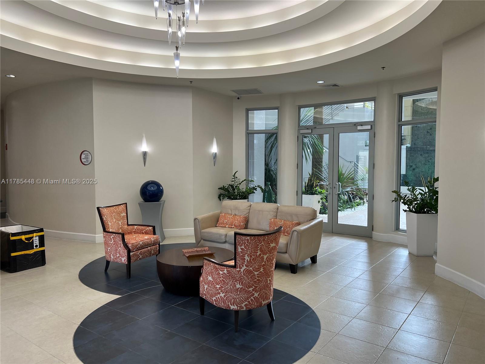 1830 Radius Drive, Unit 909 Hollywood, FL 33020 - Photo 19 of 22 a living room with furniture and a potted plant