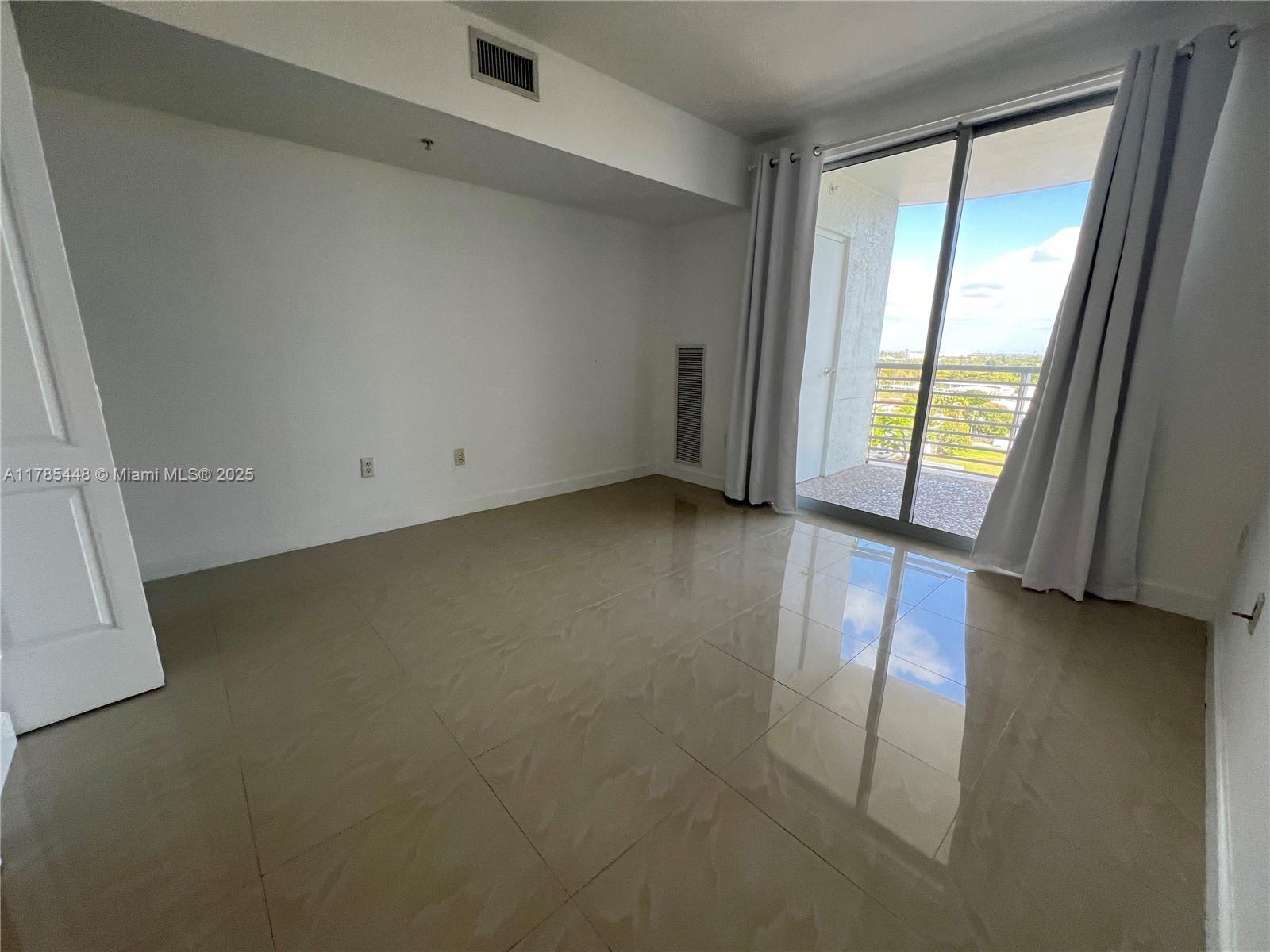 1830 Radius Drive, Unit 909 Hollywood, FL 33020 - Photo 7 of 22 an empty room with windows