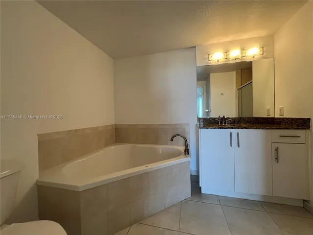 a bathroom with a bathtub and a sink