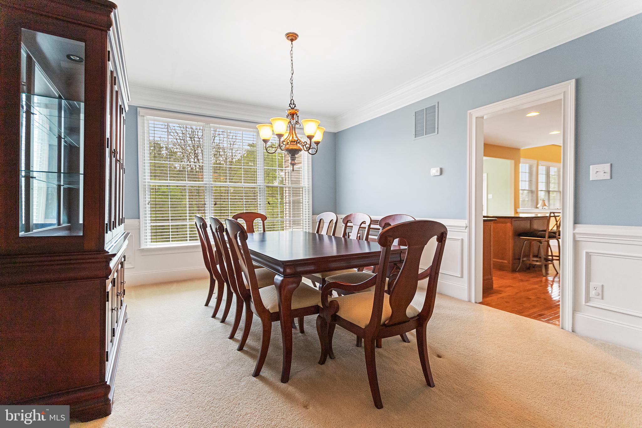103 Sloan Road West Chester, PA 19382 - Photo 12 of 56 a dining room with furniture a chandelier and wooden floor