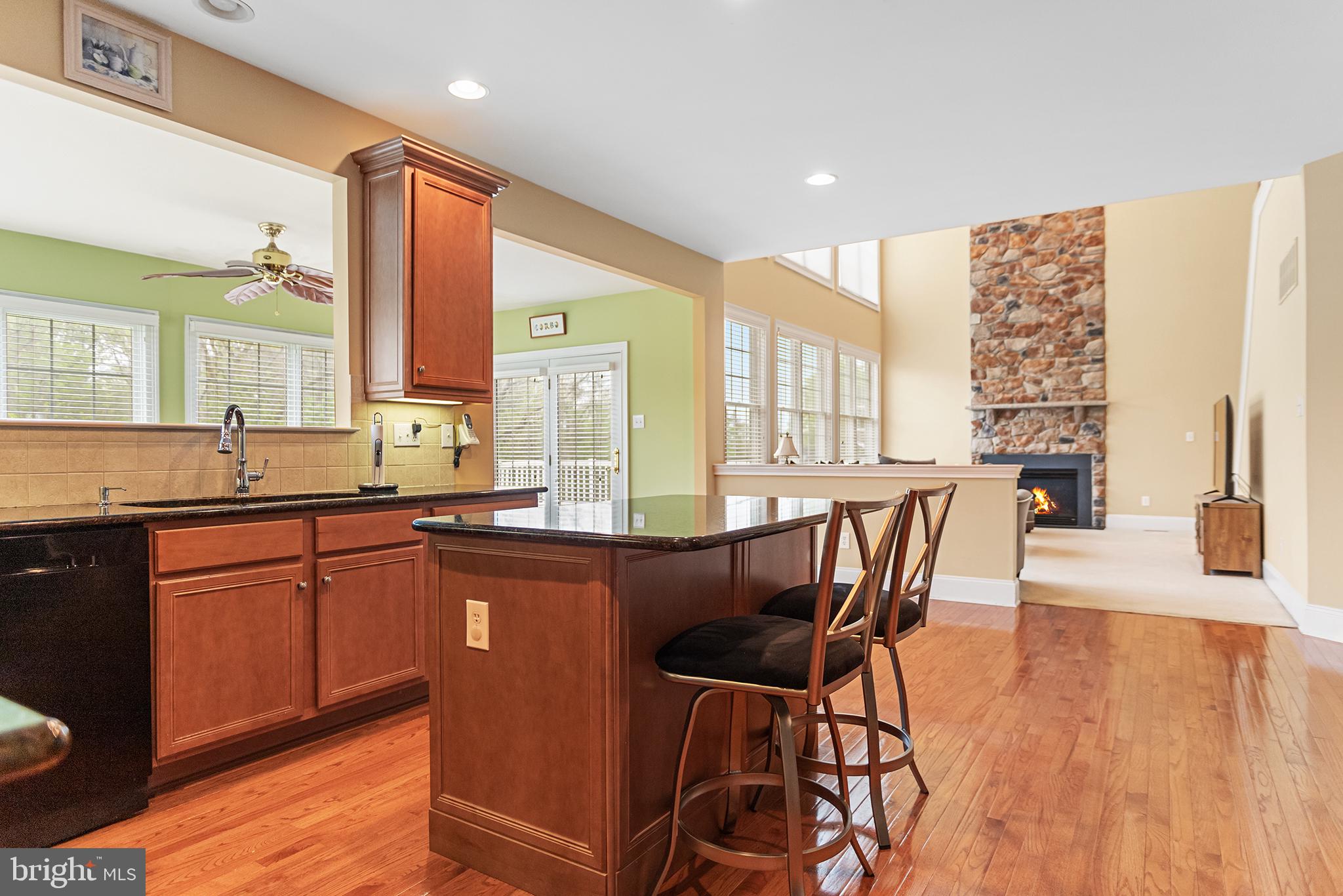 103 Sloan Road West Chester, PA 19382 - Photo 15 of 56 a kitchen with stainless steel appliances granite countertop wooden floor dining table and chairs