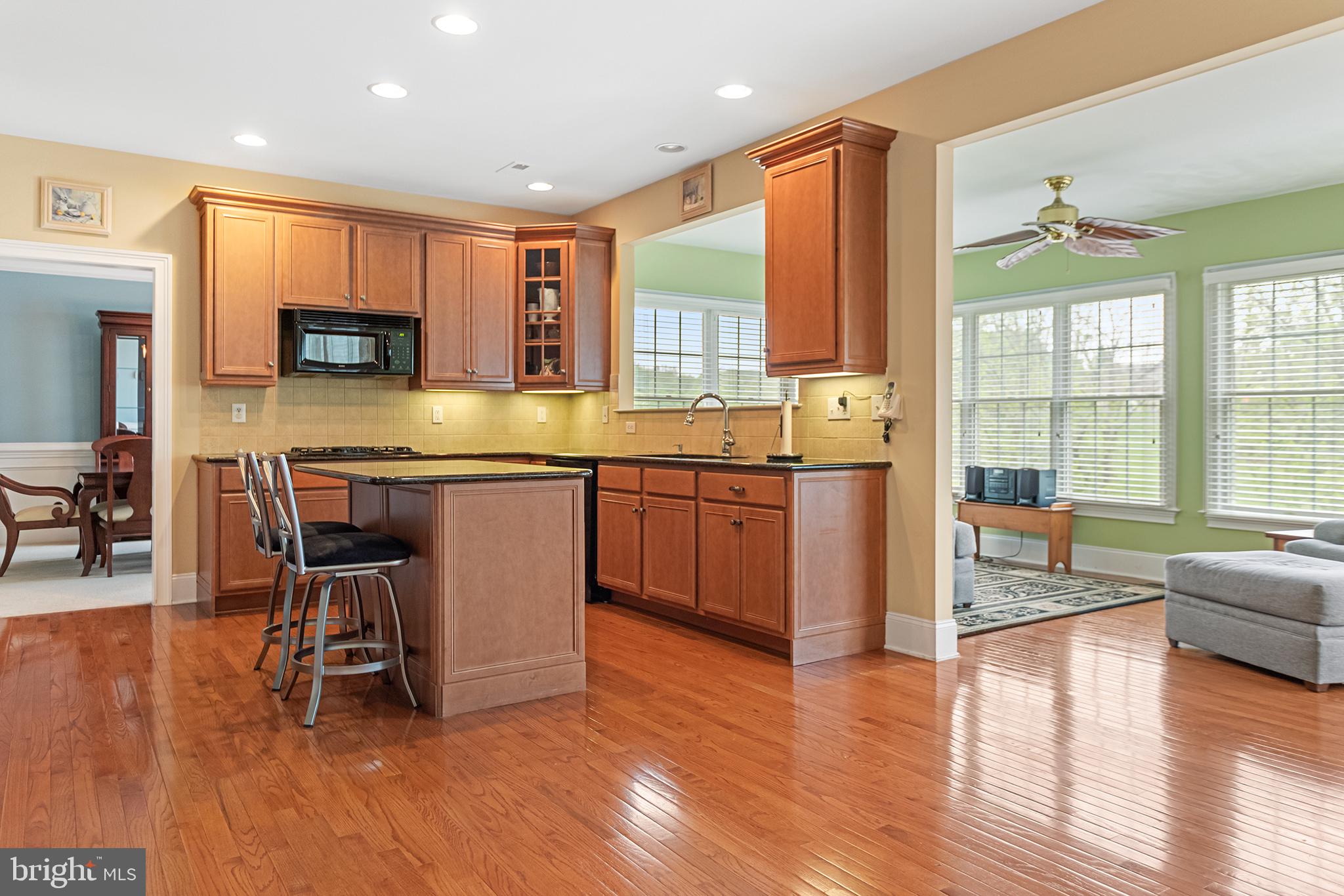 103 Sloan Road West Chester, PA 19382 - Photo 16 of 56 a kitchen with stainless steel appliances granite countertop wooden cabinets a dining table and chairs