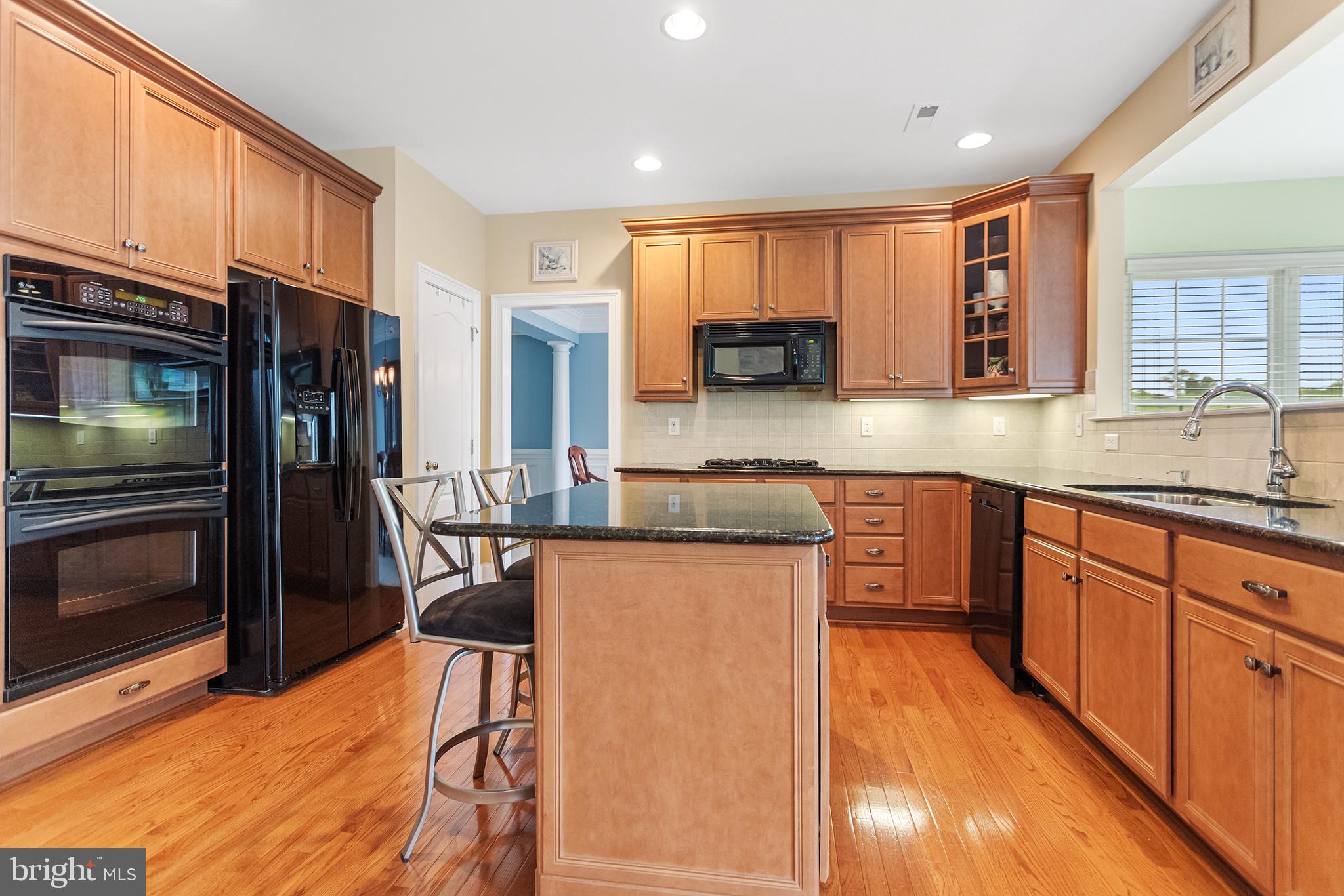103 Sloan Road West Chester, PA 19382 - Photo 17 of 56 a kitchen with stainless steel appliances granite countertop a refrigerator a stove top oven and a sink with cabinets