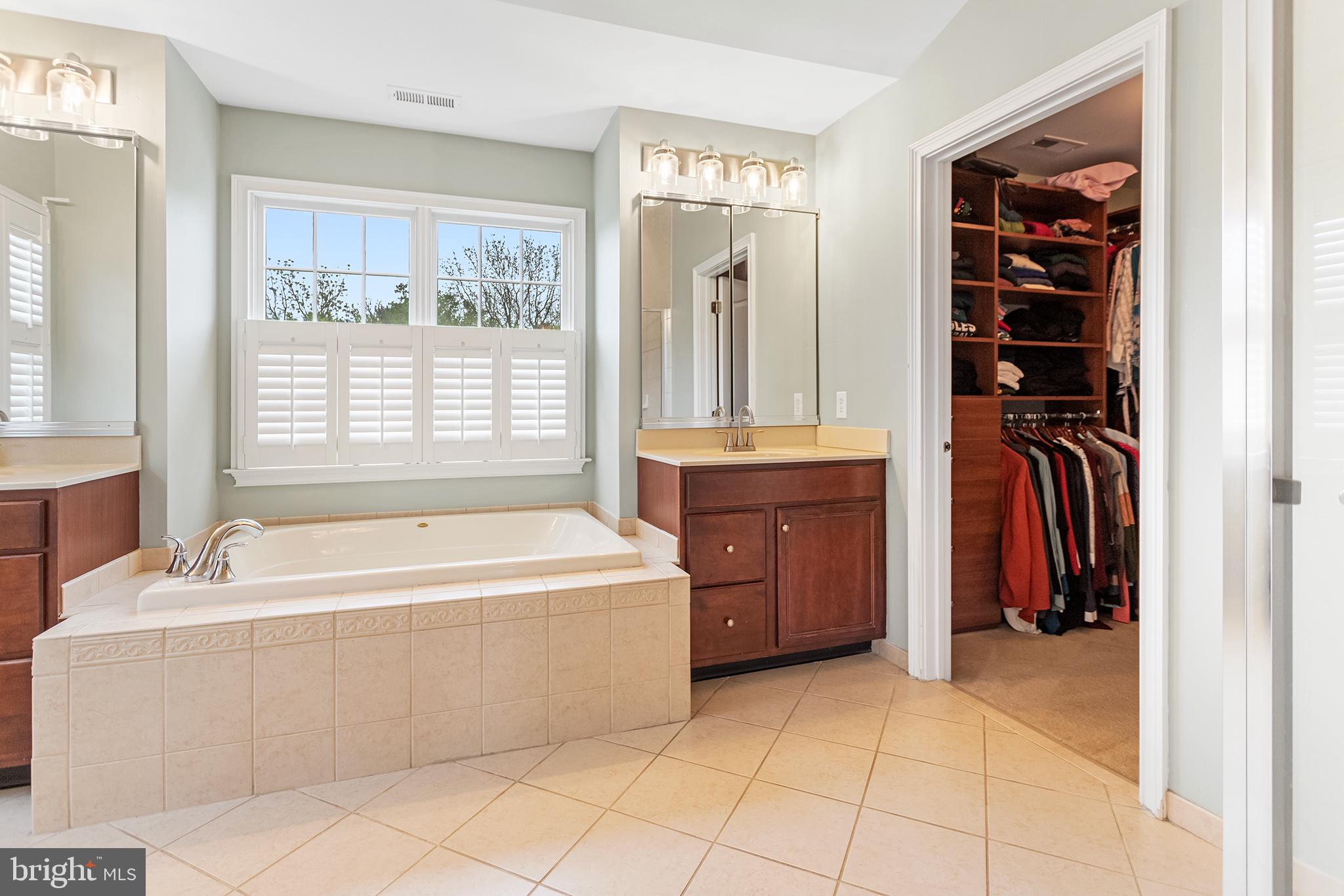 103 Sloan Road West Chester, PA 19382 - Photo 31 of 56 a spacious bathroom with a tub a sink and a mirror