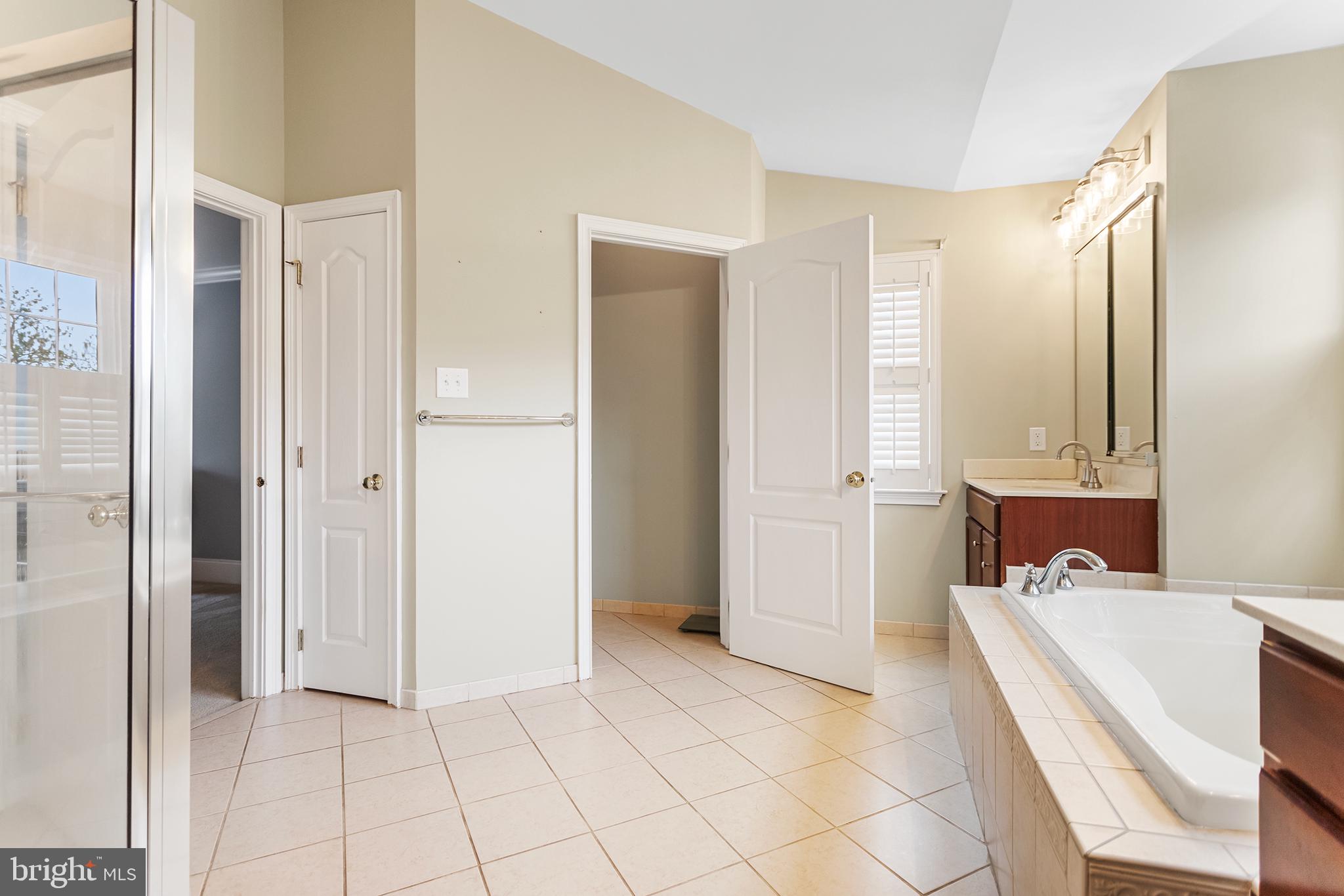 103 Sloan Road West Chester, PA 19382 - Photo 33 of 56 a view of a bathroom with a tub shower and sink
