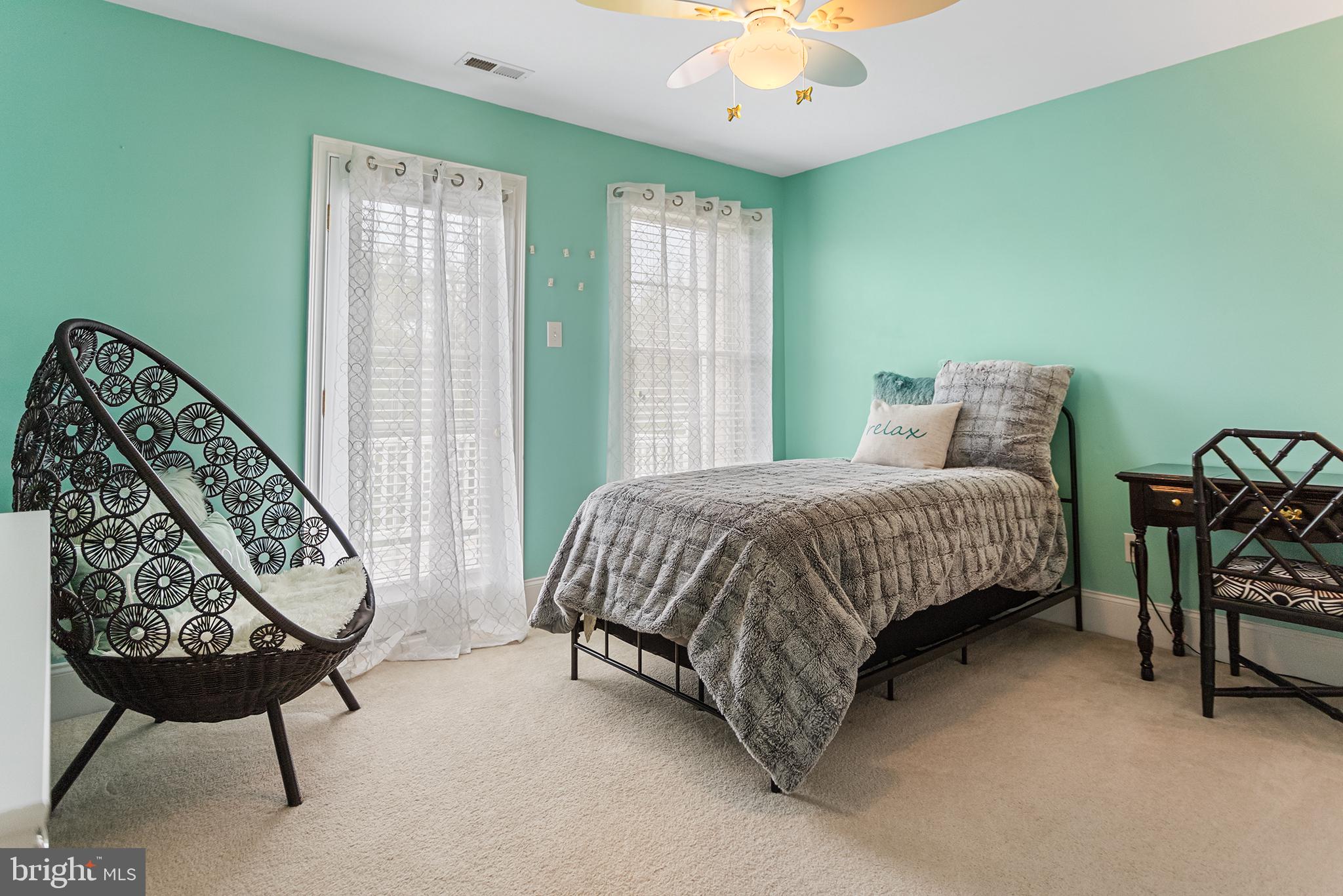 103 Sloan Road West Chester, PA 19382 - Photo 35 of 56 a bedroom with a large bed and a chandelier