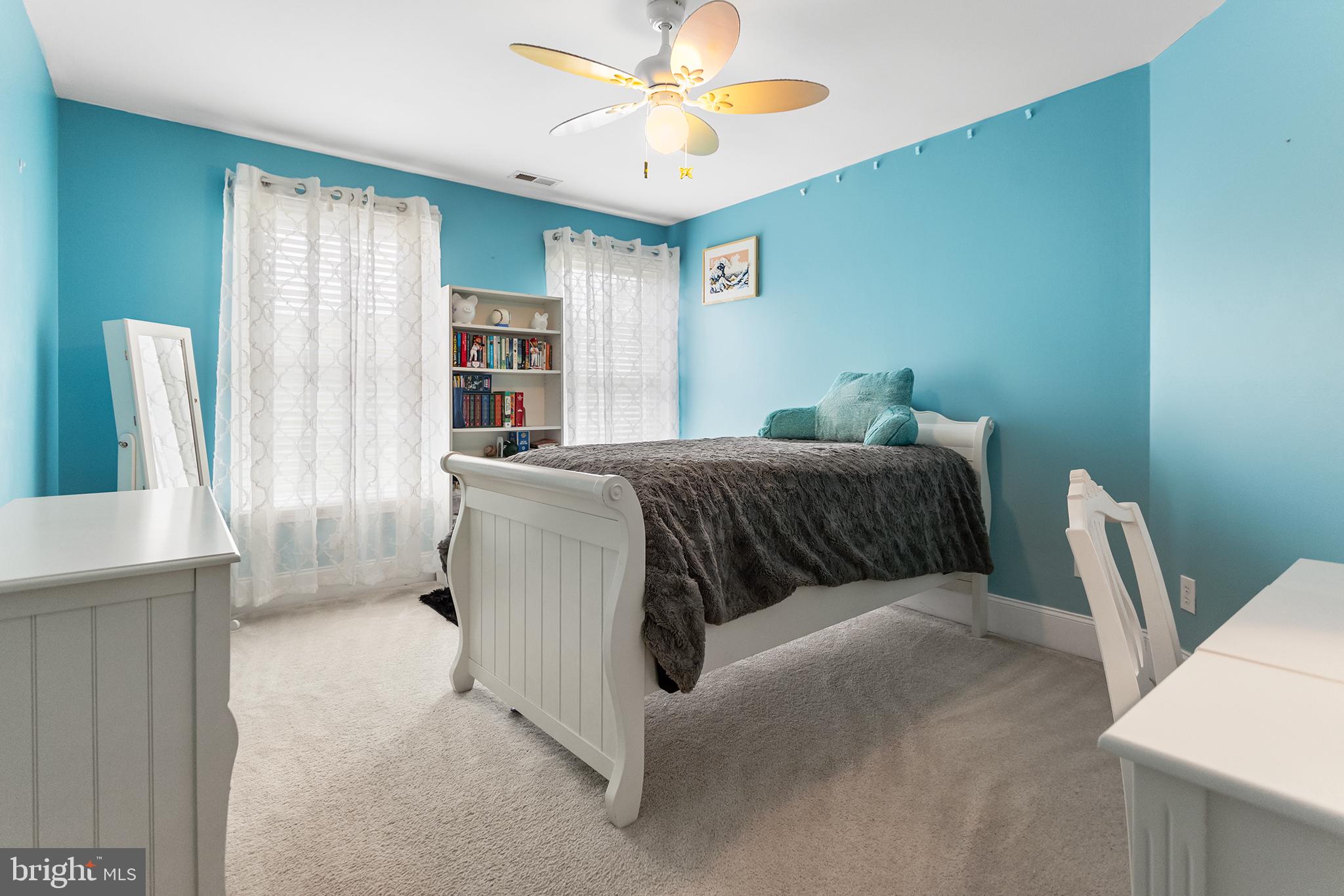 103 Sloan Road West Chester, PA 19382 - Photo 38 of 56 a spacious bedroom with a bed and a chandelier