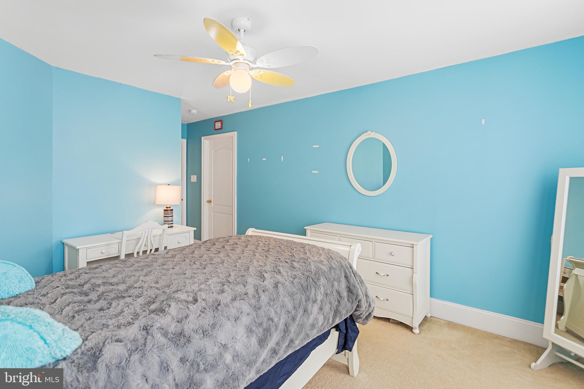 103 Sloan Road West Chester, PA 19382 - Photo 39 of 56 a bedroom with a bed and a chandelier