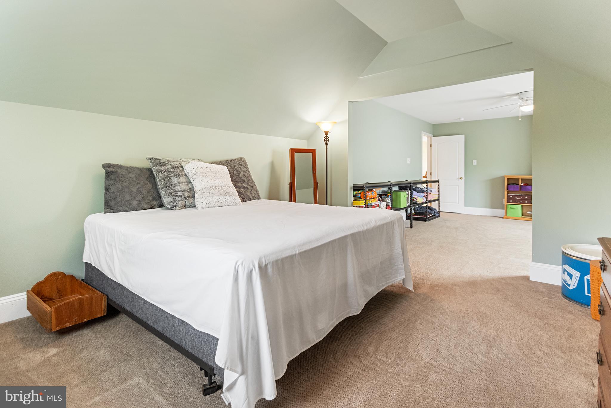 103 Sloan Road West Chester, PA 19382 - Photo 42 of 56 a spacious bedroom with a bed and a couch