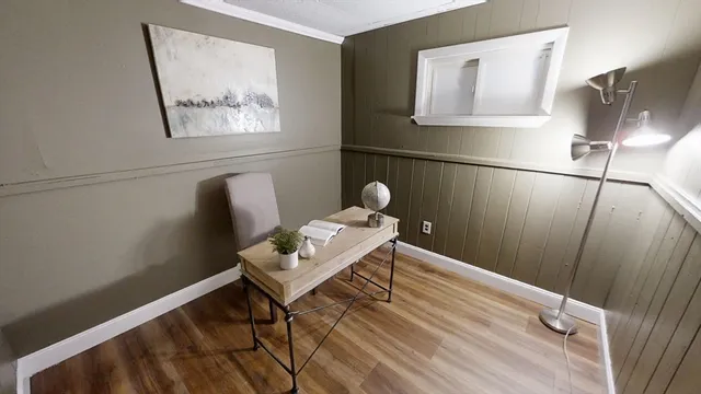 a living room with furniture a flat screen tv and a window