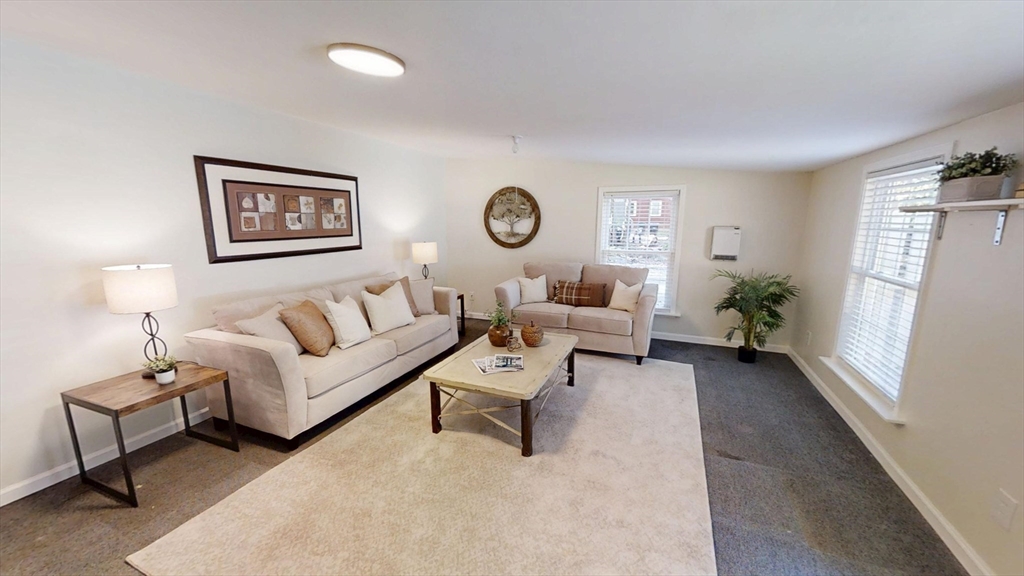 48 Pond Street Salem, NH 03079 - Photo 4 of 35 a living room with furniture and a window