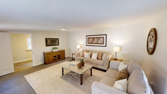 a living room with furniture a couch and a flat screen tv