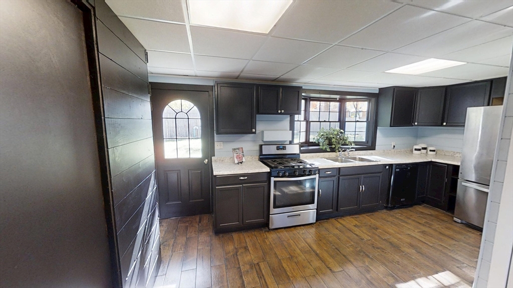 48 Pond Street Salem, NH 03079 - Photo 10 of 35 a kitchen with stainless steel appliances granite countertop a sink a stove a refrigerator cabinets and a window