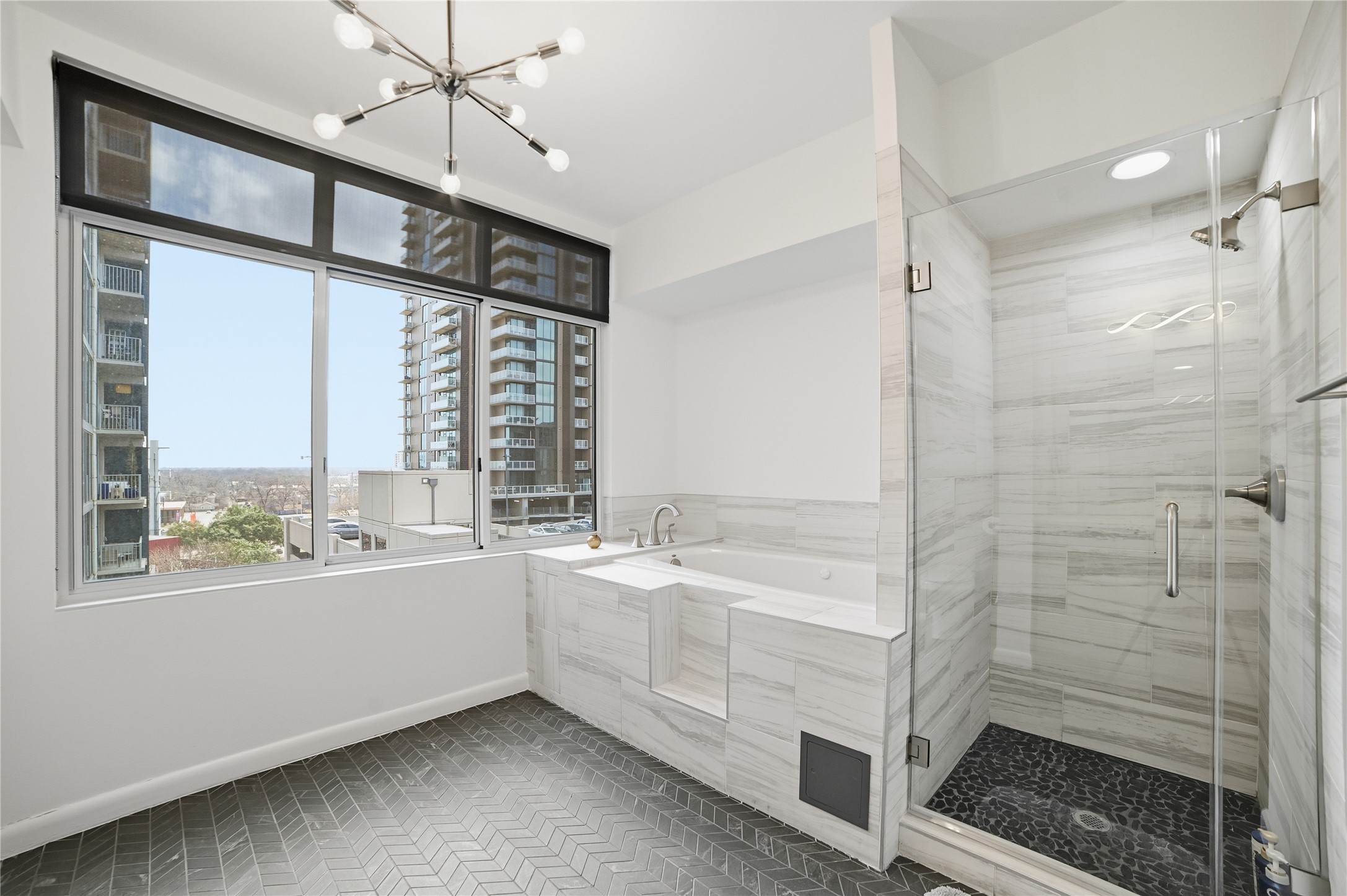 54 Rainey Street, Unit 1018 Austin, TX 78701 - Photo 19 of 32 a bathroom with a bathtub and a shower