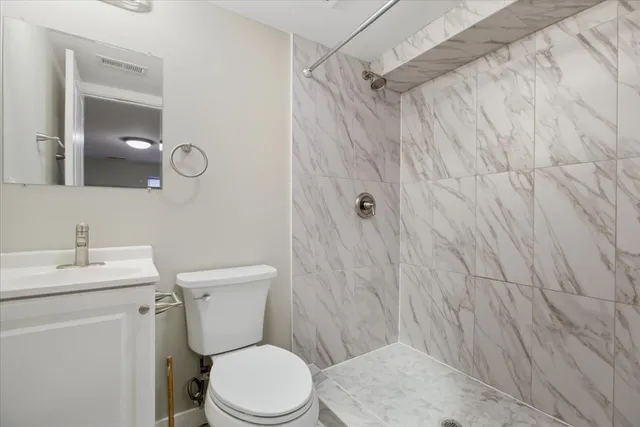 a white toilet sitting next to a bathroom sink