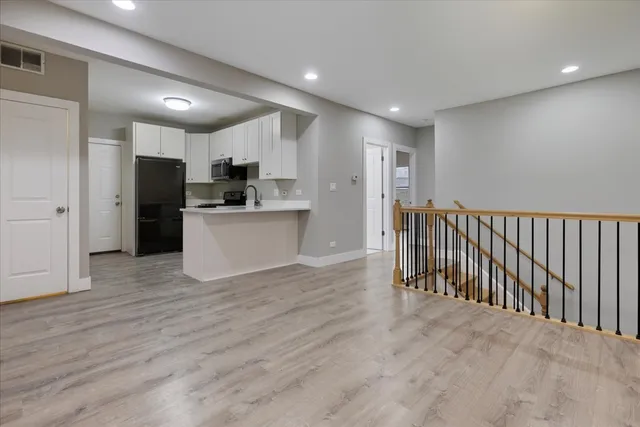 a view of a kitchen with a sink and stainless steel appliances